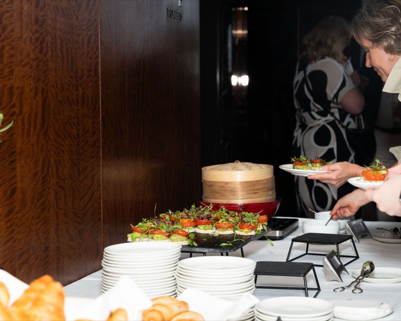 Smashed avocado and cherry tomato blinis with microgreens