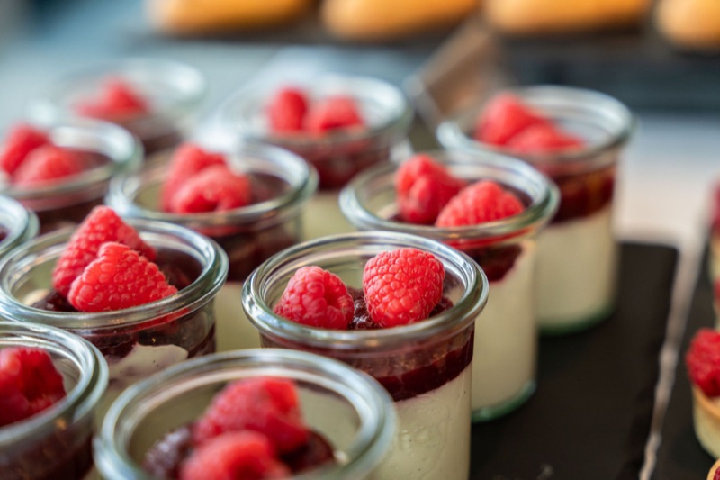 Vanilla panna cotta with raspberry coulis in glass jars