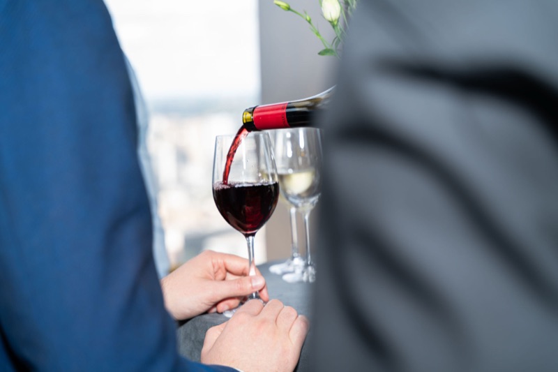 Red wine being poured at the early evening drinks reception